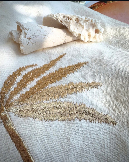 Gold palm tree hand embroidery close-up on white linen bag — Souhaib Creative Service