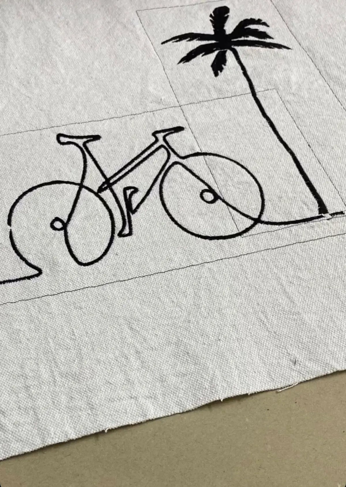 Hand-drawn bicycle and palm tree embroidery on white linen bag — Souhaib Creative Service Morocco